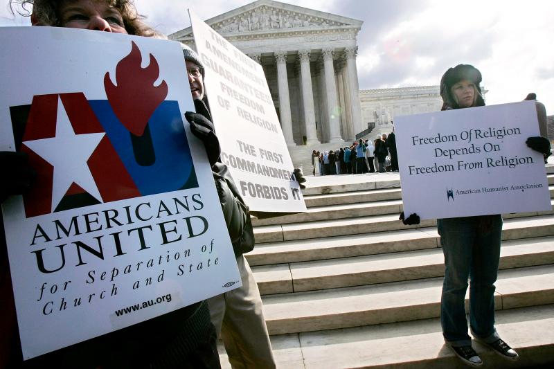 Activists hold posters during a March 2005 rally in front of the U.S. Supreme Court to support separation of church and state. The court heard two cases regarding whether Ten Commandments monuments should be displayed on government properties. Activists hold posters during a March 2005 rally in front of the U.S. Supreme Court to support separation of church and state. The court heard two cases regarding whether Ten Commandments monuments should be displayed on government properties.