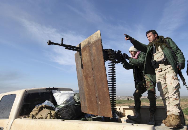Kurdish peshmerga fighters keep watch during the battle with Islamic State militants on the outskirts of Mosul on Jan. 21. Kurdish peshmerga fighters keep watch during the battle with Islamic State militants on the outskirts of Mosul on Jan. 21.