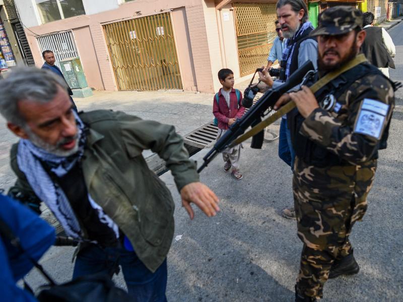 A member of the Taliban special forces pushes a journalist covering a demonstration by women protesters in Kabul on Sept. 30. A member of the Taliban special forces pushes a journalist covering a demonstration by women protesters in Kabul on Sept. 30.