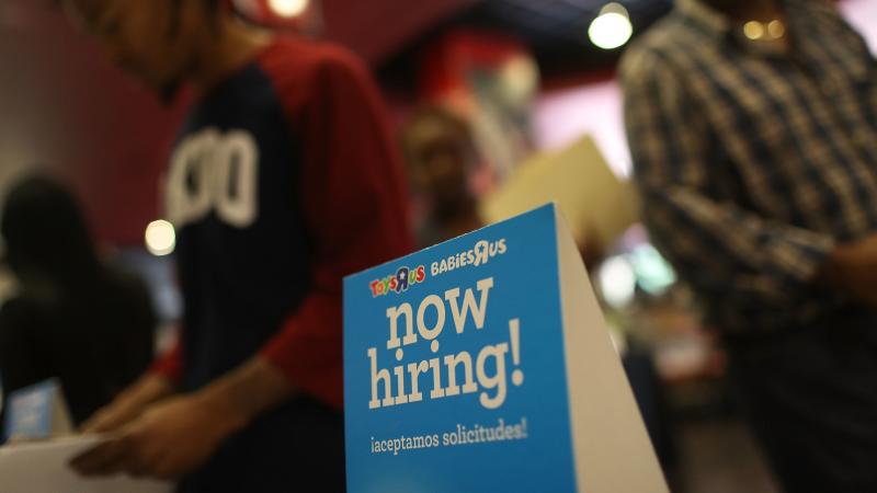 A "now hiring" sign is seen at the Toys R Us booth during the JobNewsUSA job fair at the BB&T Center in Sunrise, Fla., on Nov. 15. A "now hiring" sign is seen at the Toys R Us booth during the JobNewsUSA job fair at the BB&T Center in Sunrise, Fla., on Nov. 15.
