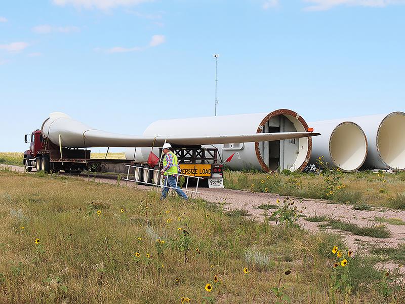 Rob Van Vleet secures a wind turbine blade on to an oversize truck at the Kimball Wind Farm in southwest Nebraska. Rob Van Vleet secures a wind turbine blade on to an oversize truck at the Kimball Wind Farm in southwest Nebraska.