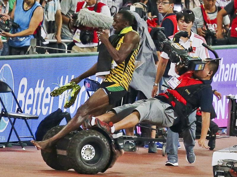Usain Bolt of Jamaica is hit by a cameraman on a Segway while celebrating his win in the 200-meter final during the 15th IAAF World Championships at National Stadium in Beijing. Usain Bolt of Jamaica is hit by a cameraman on a Segway while celebrating his win in the 200-meter final during the 15th IAAF World Championships at National Stadium in Beijing.