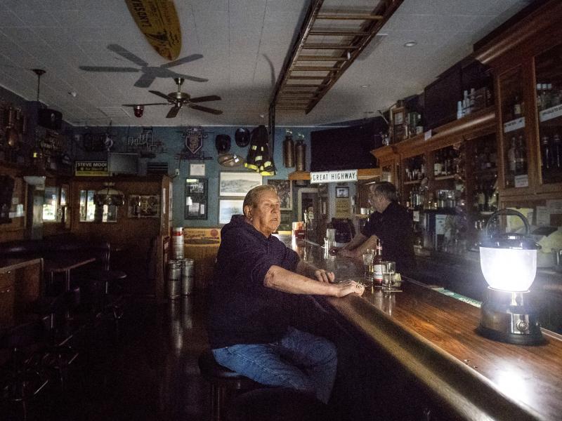 Joseph Pokorski drinks a beer at The Town Square as downtown Sonoma, Calif., remains without power on Wednesday. Joseph Pokorski drinks a beer at The Town Square as downtown Sonoma, Calif., remains without power on Wednesday.