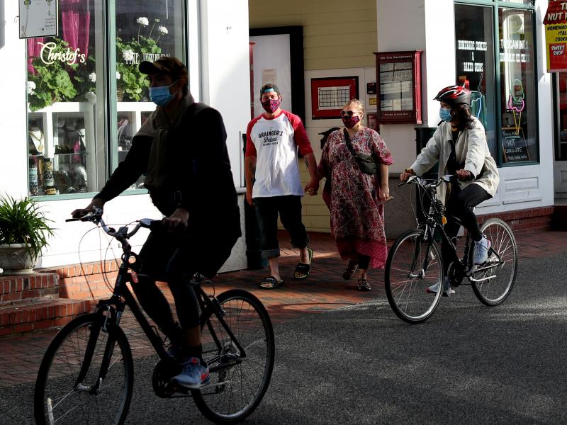 Pedestrians and cyclists head down Commercial Street in Provincetown, Mass., in May 2020. A study of a new outbreak in Provincetown found that three-quarters of those infected with the virus were fully vaccinated. Pedestrians and cyclists head down Commercial Street in Provincetown, Mass., in May 2020. A study of a new outbreak in Provincetown found that three-quarters of those infected with the virus were fully vaccinated.