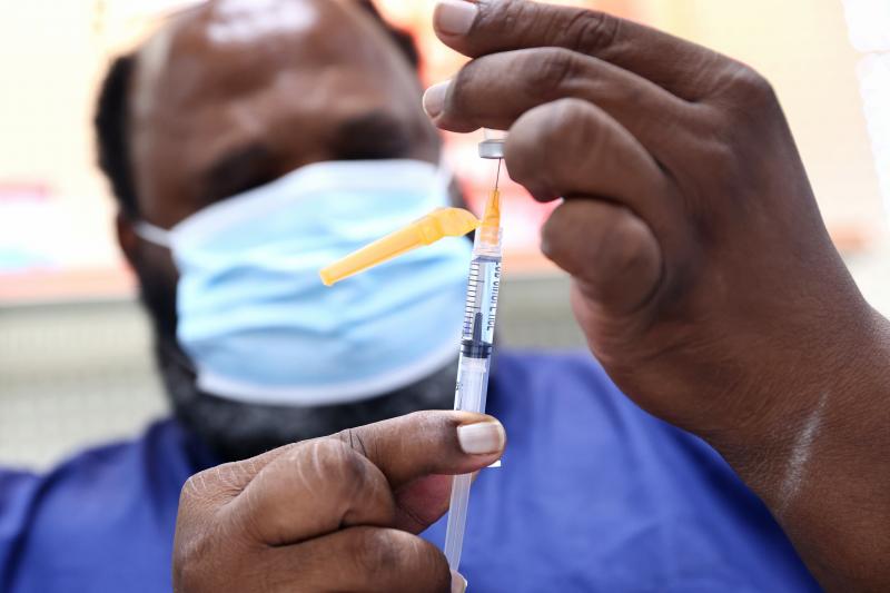 A COVID-19 vaccine dose is prepared at a pharmacy in Baton Rouge, La., on Aug. 17. About 14 million people received their first dose of a COVID-19 vaccine in August. A COVID-19 vaccine dose is prepared at a pharmacy in Baton Rouge, La., on Aug. 17. About 14 million people received their first dose of a COVID-19 vaccine in August.