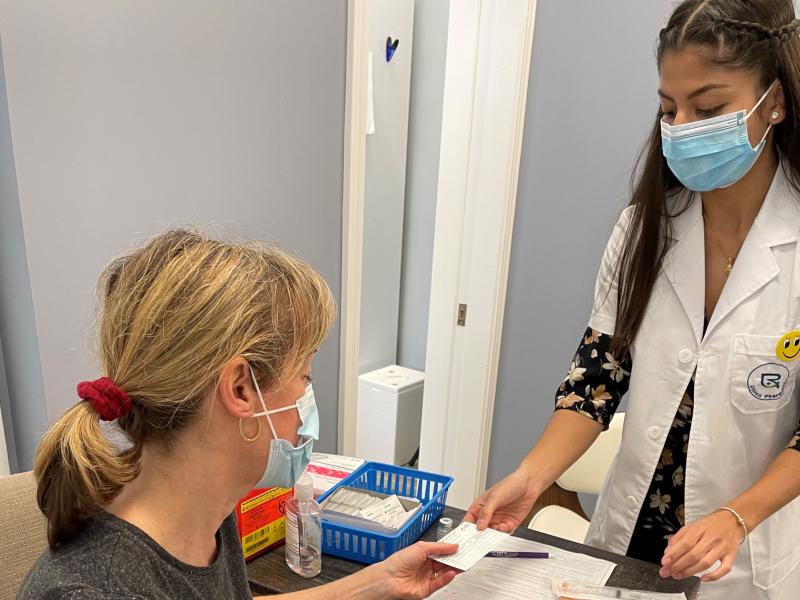 Pharmacist intern Ojashwi Giri hands a vaccination card to Linda Simansky, at Union Pharmacy in Newton, Mass. It's a kind of low-tech version of "vaccine passports" that have become the latest pandemic wedge issue. Pharmacist intern Ojashwi Giri hands a vaccination card to Linda Simansky, at Union Pharmacy in Newton, Mass. It's a kind of low-tech version of "vaccine passports" that have become the latest pandemic wedge issue.
