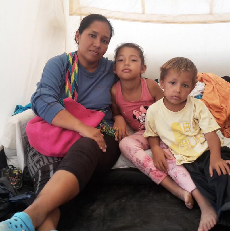 Gusmary Añez sits in a tent with two of her children. She and her husband, along with their four children, had been sleeping outdoors in Maicao, a Colombian town near the Venezuelan border. Now they live in one of 60 tents at the camp that house more tha Gusmary Añez sits in a tent with two of her children. She and her husband, along with their four children, had been sleeping outdoors in Maicao, a Colombian town near the Venezuelan border. Now they live in one of 60 tents at the camp that house more tha