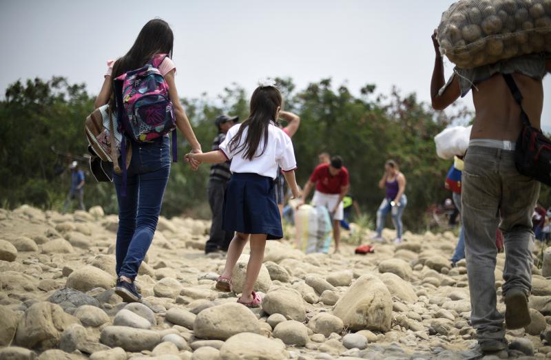 Venezuelan Leidy Navarro (left) walks with her daughter Valentina Caceres back to their home in Ureña, Venezuela, after picking her up at school in Cúcuta, Colombia, in March. Venezuelan Leidy Navarro (left) walks with her daughter Valentina Caceres back to their home in Ureña, Venezuela, after picking her up at school in Cúcuta, Colombia, in March.