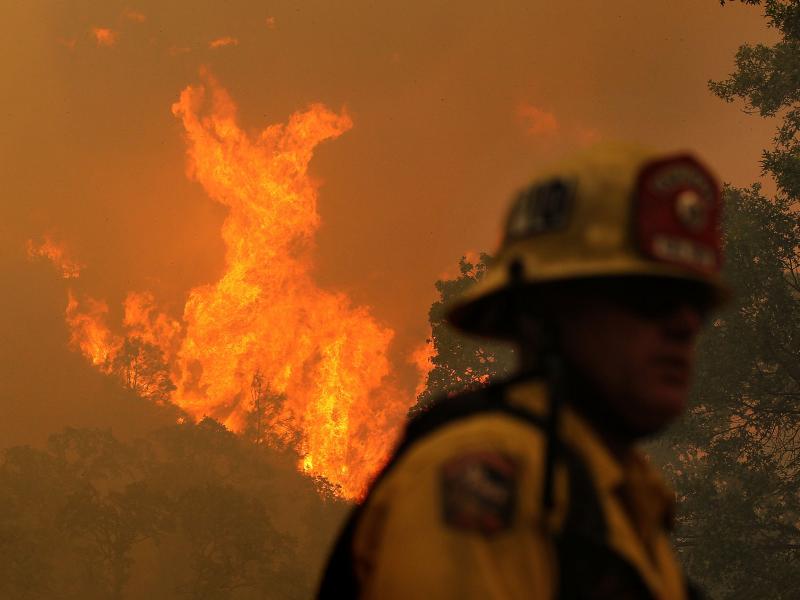 A firefighter monitors flames from the Rocky Fire as it approaches a home late last month. The wildfire has consumed thousands of acres in just over a week. A firefighter monitors flames from the Rocky Fire as it approaches a home late last month. The wildfire has consumed thousands of acres in just over a week.