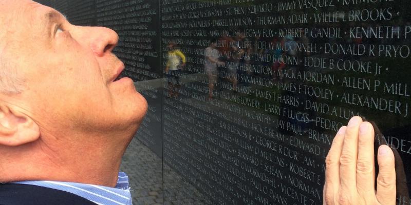 Jan Scruggs gazes up at the names of fellow military service members inscribed on the Vietnam Veterans Memorial in Washington, D.C. Jan Scruggs gazes up at the names of fellow military service members inscribed on the Vietnam Veterans Memorial in Washington, D.C.