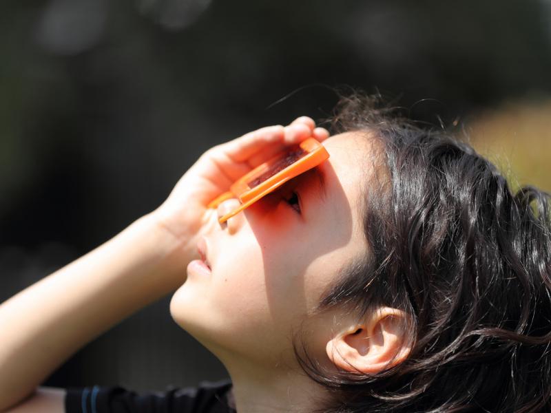 A child watches a solar eclipse on May 20, 2012, in Japan. A child watches a solar eclipse on May 20, 2012, in Japan.