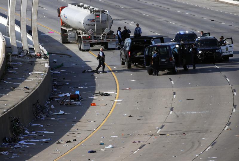 Police clear the area where a tanker truck rushed to a stop among protesters on an interstate highway on Sunday in Minneapolis. Police clear the area where a tanker truck rushed to a stop among protesters on an interstate highway on Sunday in Minneapolis.
