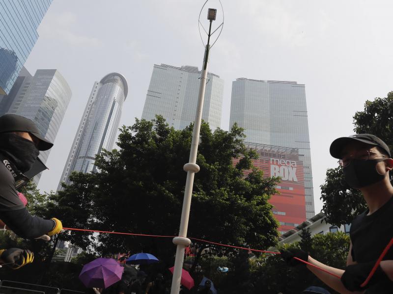 Demonstrators try to pull down a smart lamppost during the protest in Hong Kong on Saturday that turned violent. The smart lampposts are raising fears of stepped-up surveillance from authorities. Demonstrators try to pull down a smart lamppost during the protest in Hong Kong on Saturday that turned violent. The smart lampposts are raising fears of stepped-up surveillance from authorities.