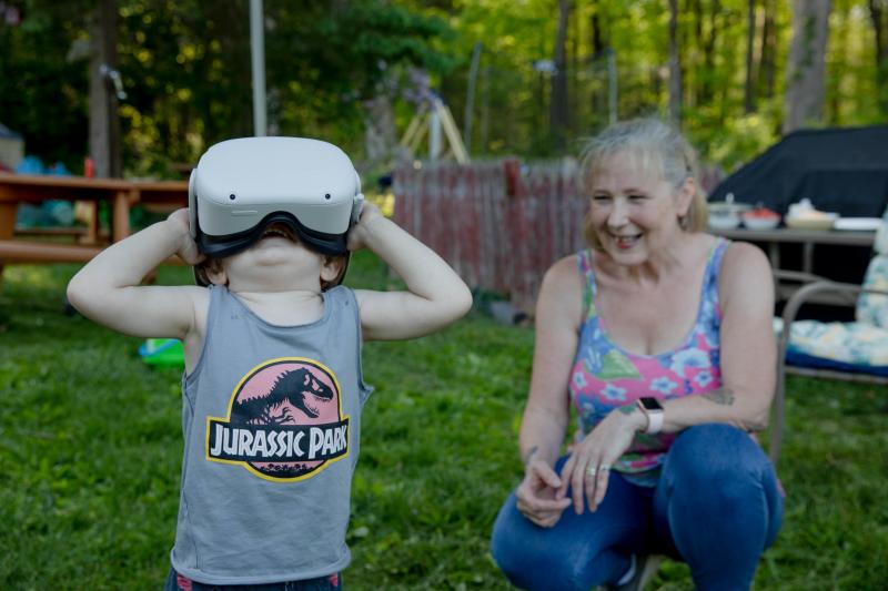 Linda Munson's youngest grandson, Daniel Gomez, 2, tries on an Oculus headset in her yard in Berlin, Conn. Playing different virtual reality games has become her family's regular Sunday activity, Munson said. Linda Munson's youngest grandson, Daniel Gomez, 2, tries on an Oculus headset in her yard in Berlin, Conn. Playing different virtual reality games has become her family's regular Sunday activity, Munson said.