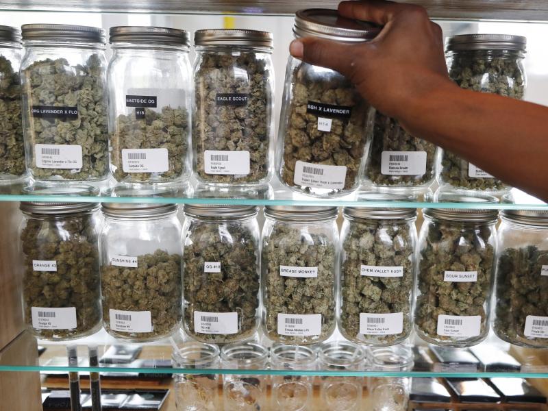 Michigan has become the first state in the Midwest to legalize recreational marijuana, after voters approved a ballot measure Tuesday. Here, a clerk reaches for a container of marijuana buds at Utopia Gardens, a medical marijuana dispensary in Detroit. Michigan has become the first state in the Midwest to legalize recreational marijuana, after voters approved a ballot measure Tuesday. Here, a clerk reaches for a container of marijuana buds at Utopia Gardens, a medical marijuana dispensary in Detroit.