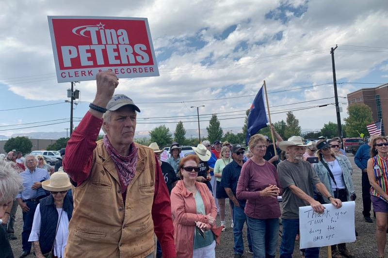 Supporters of Mesa County clerk Tina Peters appear at a rally for her last month in Grand Junction, Colo. Peters is under investigation over the unauthorized release of sensitive information about voting equipment. Supporters of Mesa County clerk Tina Peters appear at a rally for her last month in Grand Junction, Colo. Peters is under investigation over the unauthorized release of sensitive information about voting equipment.