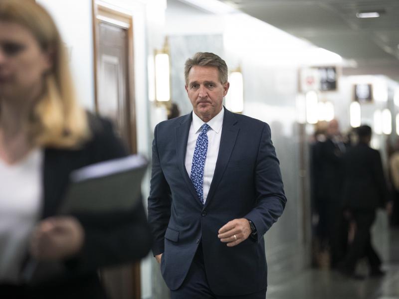 Sen. Jeff Flake arrives back at the Senate Judiciary Committee hearing on Thursday following a break. After announcing Friday morning that he would vote to confirm Brett Kavanaugh to the Supreme Court, Flake was confronted in an emotional scene by two wom Sen. Jeff Flake arrives back at the Senate Judiciary Committee hearing on Thursday following a break. After announcing Friday morning that he would vote to confirm Brett Kavanaugh to the Supreme Court, Flake was confronted in an emotional scene by two wom