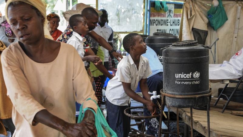 The WHO says the current Ebola outbreak is an emergency in the Democratic Republic of the Congo and the region — but not on the international level. Here, people arriving from the DRC on Friday wash their hands with chlorinated water to prevent the spre The WHO says the current Ebola outbreak is an emergency in the Democratic Republic of the Congo and the region — but not on the international level. Here, people arriving from the DRC on Friday wash their hands with chlorinated water to prevent the spre