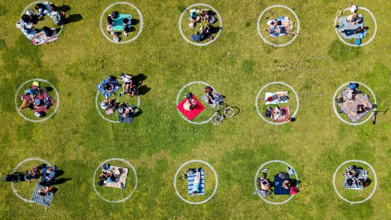 An aerial view shows people gathered in painted circles on the grass encouraging social distancing last week at Dolores Park in San Francisco. An aerial view shows people gathered in painted circles on the grass encouraging social distancing last week at Dolores Park in San Francisco.