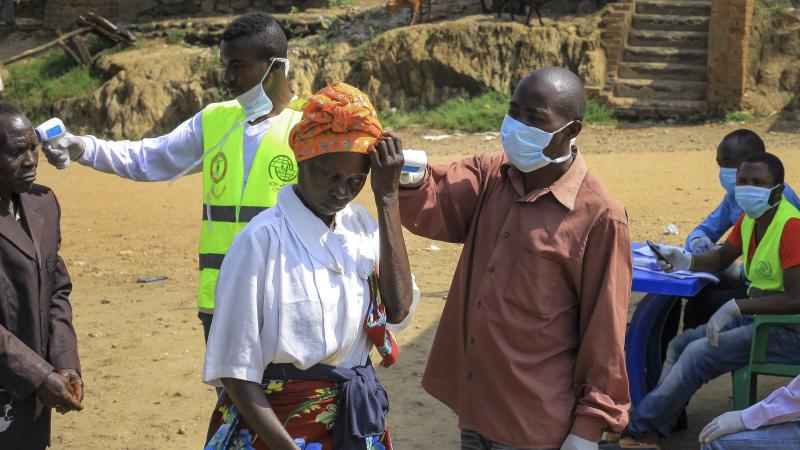 People crossing the border have their temperature taken to check for symptoms of Ebola, near Kasindi, eastern Congo, on Wednesday. People crossing the border have their temperature taken to check for symptoms of Ebola, near Kasindi, eastern Congo, on Wednesday.