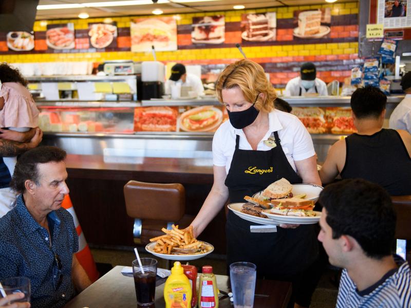 A server delivers food to customers dining at a restaurant in Los Angeles on Aug. 7. Restaurants are boosting pay to attract workers, and that could have an impact on already-high inflation. A server delivers food to customers dining at a restaurant in Los Angeles on Aug. 7. Restaurants are boosting pay to attract workers, and that could have an impact on already-high inflation.