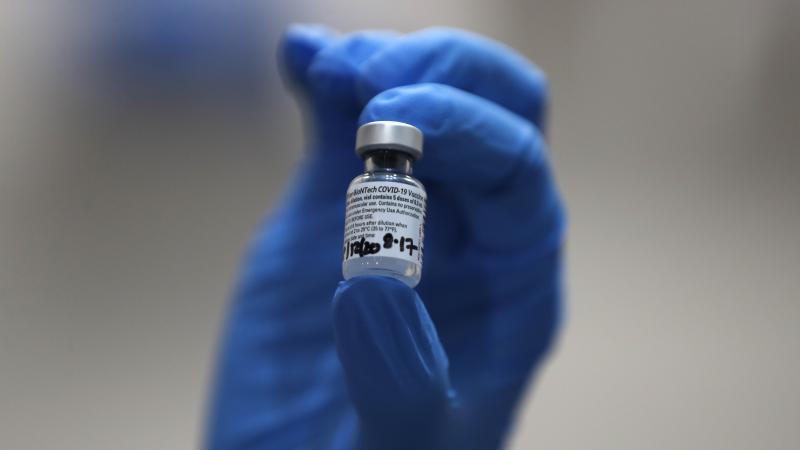 A nurse holds a vial of the COVID-19 vaccine produced by Pfizer and BioNTech, in London earlier this week. Food and Drug Administration officials in the U.S. sought to reassure the public about the vaccine Saturday after authorizing it for emergency use. A nurse holds a vial of the COVID-19 vaccine produced by Pfizer and BioNTech, in London earlier this week. Food and Drug Administration officials in the U.S. sought to reassure the public about the vaccine Saturday after authorizing it for emergency use.