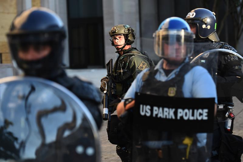 U.S. Park Police and other federal officers hold a perimeter near the White House on June 1 as demonstrators gather to protest the killing of George Floyd. U.S. Park Police and other federal officers hold a perimeter near the White House on June 1 as demonstrators gather to protest the killing of George Floyd.