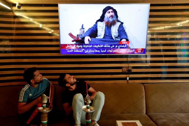 Iraqi youth watch the news about ISIS leader Abu Bakr al-Baghdadi's death, in Najaf, Iraq, on Sunday. Iraqi youth watch the news about ISIS leader Abu Bakr al-Baghdadi's death, in Najaf, Iraq, on Sunday.