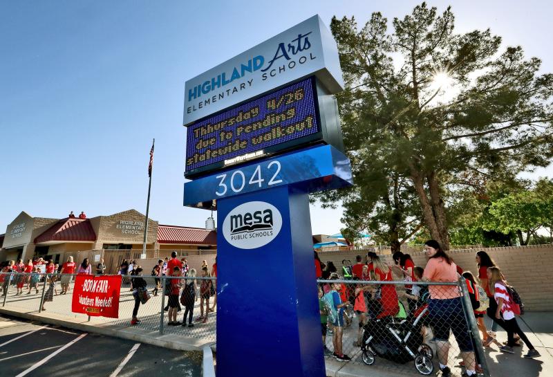 The digital marquee outside Highland Arts Elementary School in Mesa, Ariz., seen at the start of class Wednesday, warns of the effects of the teacher walkout on Thursday. The digital marquee outside Highland Arts Elementary School in Mesa, Ariz., seen at the start of class Wednesday, warns of the effects of the teacher walkout on Thursday.