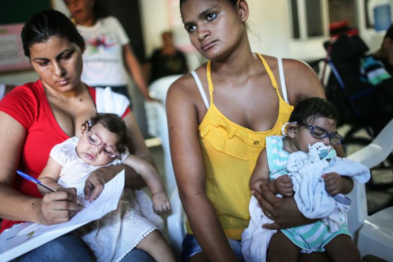 Infants born with microcephaly are held by mothers at a meeting for mothers of children with special needs in Recife, Brazil. Infants born with microcephaly are held by mothers at a meeting for mothers of children with special needs in Recife, Brazil.