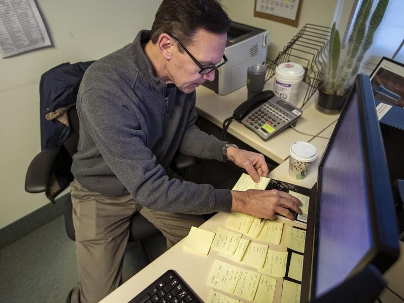 Army veteran Chris Riga survived multiple blast injuries in deployments in Afghanistan and Iraq. He rearranges sticky notes on his desk to assist him in remembering tasks he has to do throughout the day at his job as patient experience coordinator at the Army veteran Chris Riga survived multiple blast injuries in deployments in Afghanistan and Iraq. He rearranges sticky notes on his desk to assist him in remembering tasks he has to do throughout the day at his job as patient experience coordinator at the