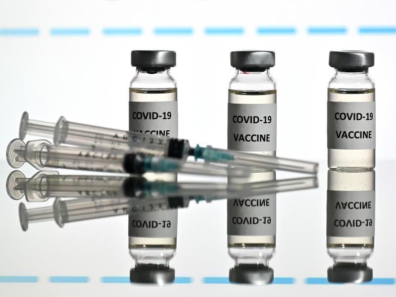 An illustration picture shows vials with COVID-19 vaccine stickers attached and syringes with the logo of U.S. biotechnology company Moderna on November 17. An illustration picture shows vials with COVID-19 vaccine stickers attached and syringes with the logo of U.S. biotechnology company Moderna on November 17.