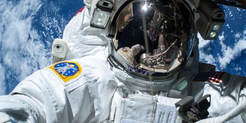 Extravehicular crewmember 2 (EV2) Terry Virts is reflected in the helmet visor of EV1 Barry Wilmore during Extravehicular Activity 29 (EVA 29). Earth is in the background. Extravehicular crewmember 2 (EV2) Terry Virts is reflected in the helmet visor of EV1 Barry Wilmore during Extravehicular Activity 29 (EVA 29). Earth is in the background.
