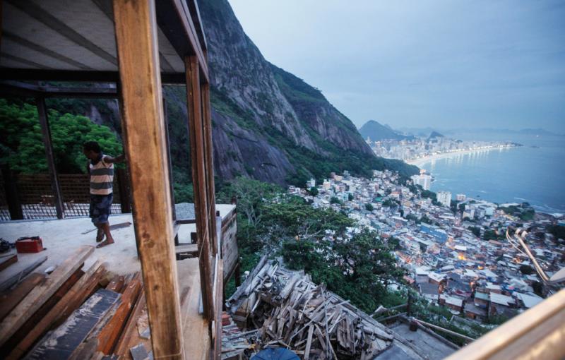 A worker stands in a construction project in a favela, or shantytown, in Rio de Janeiro, Brazil. The government has helped drive down income inequality by investing in basic services like health care, education and pensions. A worker stands in a construction project in a favela, or shantytown, in Rio de Janeiro, Brazil. The government has helped drive down income inequality by investing in basic services like health care, education and pensions.
