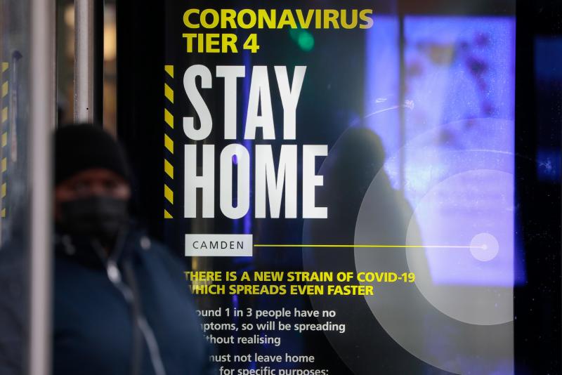 A poster about the new, fast-spreading variant of the coronavirus warns some Britons to stay home. The sign is displayed near King's Cross railway station in London. A poster about the new, fast-spreading variant of the coronavirus warns some Britons to stay home. The sign is displayed near King's Cross railway station in London.