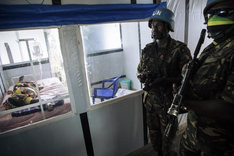 United Nations peacekeepers stand next to a patient during a visit of the U.N. secretary-general at an Ebola treatment center in Mangina, North Kivu province, last September. United Nations peacekeepers stand next to a patient during a visit of the U.N. secretary-general at an Ebola treatment center in Mangina, North Kivu province, last September.