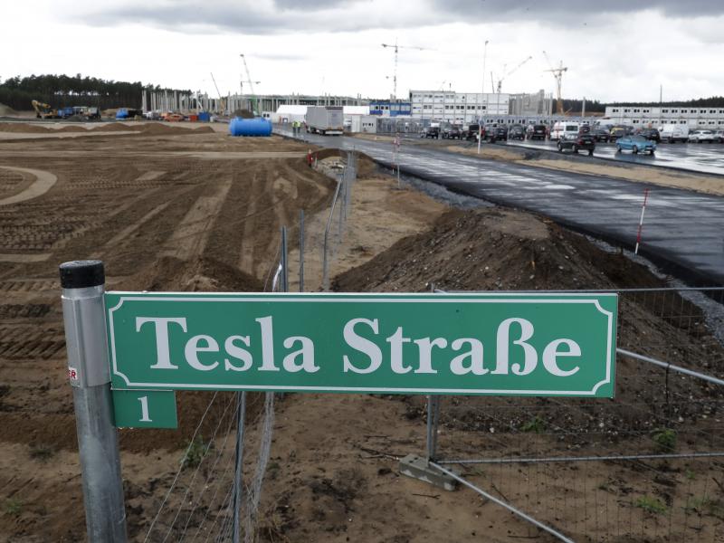 A street sign says "Tesla Street 1" in front of the construction site of the Tesla Gigafactory near Berlin. The electric automaker plans to start building cars this summer at its first European production site. A street sign says "Tesla Street 1" in front of the construction site of the Tesla Gigafactory near Berlin. The electric automaker plans to start building cars this summer at its first European production site.