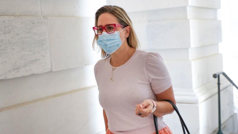 Sen. Kyrsten Sinema, D-Ariz., arrives at the U.S. Capitol on Oct. 5. Her opposition to Democrats' proposed spending package is forcing changes, but her specific positions have been hard to pin down. Sen. Kyrsten Sinema, D-Ariz., arrives at the U.S. Capitol on Oct. 5. Her opposition to Democrats' proposed spending package is forcing changes, but her specific positions have been hard to pin down.