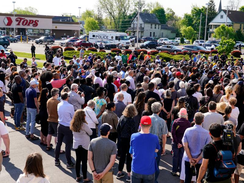 People gather outside the scene of a shooting at a supermarket in Buffalo, N.Y., Sunday, May 15, 2022. People gather outside the scene of a shooting at a supermarket in Buffalo, N.Y., Sunday, May 15, 2022.