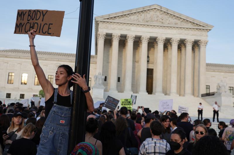 A person holds a sign during a rally in front of the Supreme Court on Tuesday in response to its leaked draft decision to overturn Roe v. Wade. A person holds a sign during a rally in front of the Supreme Court on Tuesday in response to its leaked draft decision to overturn Roe v. Wade.