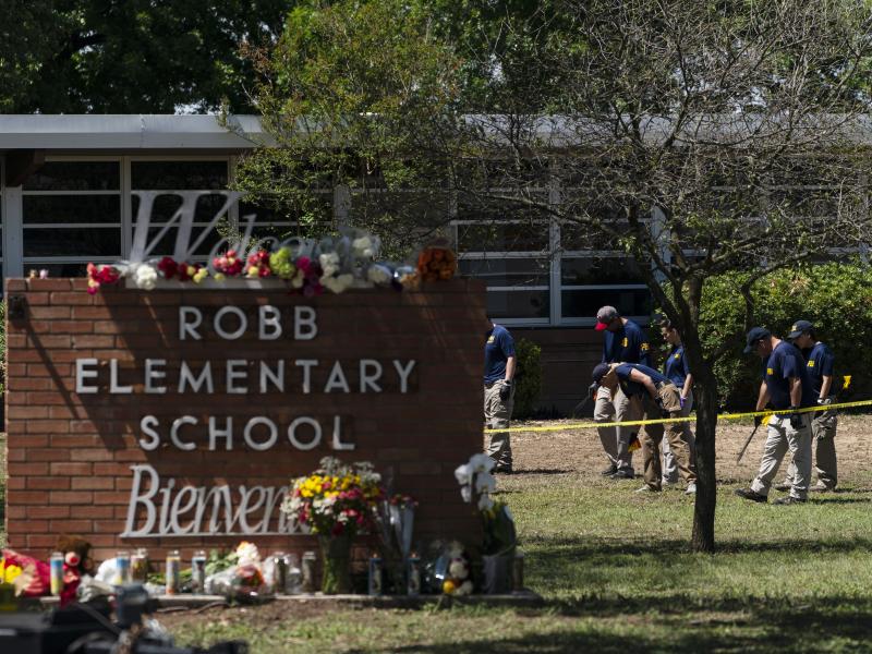 Investigators search for evidence outside Robb Elementary School in Uvalde, Texas, on Wednesday, the day after a mass shooting took place there. Investigators search for evidence outside Robb Elementary School in Uvalde, Texas, on Wednesday, the day after a mass shooting took place there.