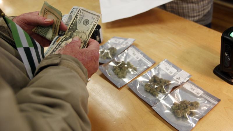 A customer buys marijuana at Harborside dispensary in Oakland, Calif., on Monday. A customer buys marijuana at Harborside dispensary in Oakland, Calif., on Monday.