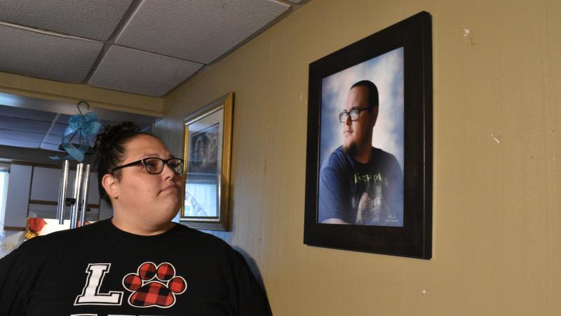 Stephanie Rimel looks at a photo of her brother Kyle Dixon, 27, who died of COVID-19 on Jan. 20. She says that during his illness and after his death, some people made insensitive comments or denied the pandemic's reality. Stephanie Rimel looks at a photo of her brother Kyle Dixon, 27, who died of COVID-19 on Jan. 20. She says that during his illness and after his death, some people made insensitive comments or denied the pandemic's reality.