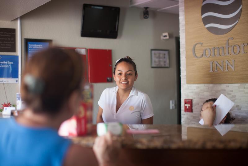 Flor Garcia talks to a guest at the Comfort Inn in Fort Myers, Fla. The hotel has become a second home for local residents who find themselves evacuating there during hurricanes. Flor Garcia talks to a guest at the Comfort Inn in Fort Myers, Fla. The hotel has become a second home for local residents who find themselves evacuating there during hurricanes.