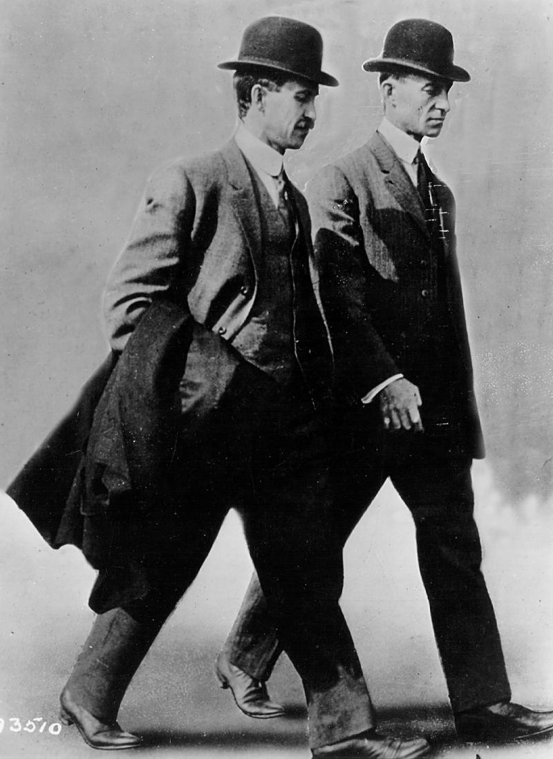 Brothers and aviation pioneers Orville and Wilbur Wright walk together in 1910. Brothers and aviation pioneers Orville and Wilbur Wright walk together in 1910.