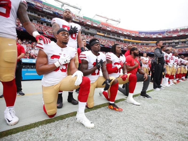 Members of the San Francisco 49ers kneel with teammates during the national anthem before playing the Washington Redskins at FedEx Field in October. Members of the San Francisco 49ers kneel with teammates during the national anthem before playing the Washington Redskins at FedEx Field in October.