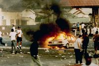 A car burns as looters take to the streets at the intersection of Florence and Normandie avenues — considered the flashpoint of the LA riots — on April 29, 1992. A car burns as looters take to the streets at the intersection of Florence and Normandie avenues — considered the flashpoint of the LA riots — on April 29, 1992.