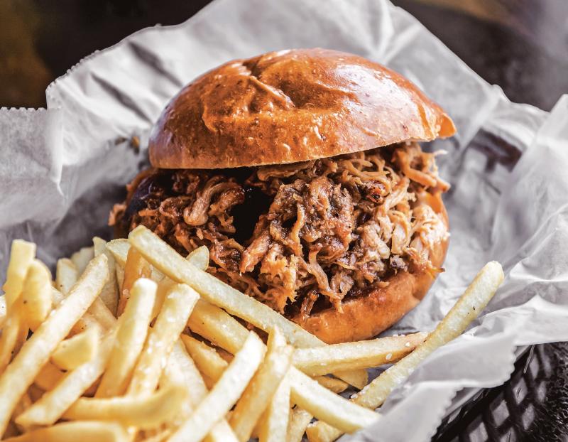 A smoked pulled chicken sandwich from Operation BBQ Relief. A smoked pulled chicken sandwich from Operation BBQ Relief.