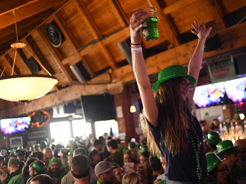 A woman dances while sitting on her friend's shoulders during St. Patrick's Day festivities in Denver last year. A woman dances while sitting on her friend's shoulders during St. Patrick's Day festivities in Denver last year.