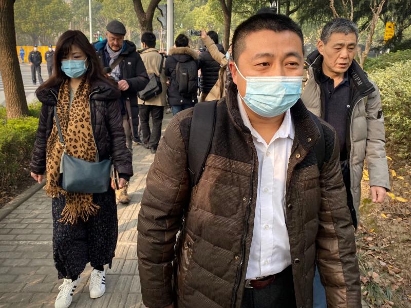 Lawyer Ren Quanniu (center), representing Chinese citizen journalist Zhang Zhan who reported on Wuhan's COVID-19 outbreak and was placed in detention since May, arrives at the Shanghai Pudong New District People's Court where Zhang is set for trial in Sha Lawyer Ren Quanniu (center), representing Chinese citizen journalist Zhang Zhan who reported on Wuhan's COVID-19 outbreak and was placed in detention since May, arrives at the Shanghai Pudong New District People's Court where Zhang is set for trial in Sha